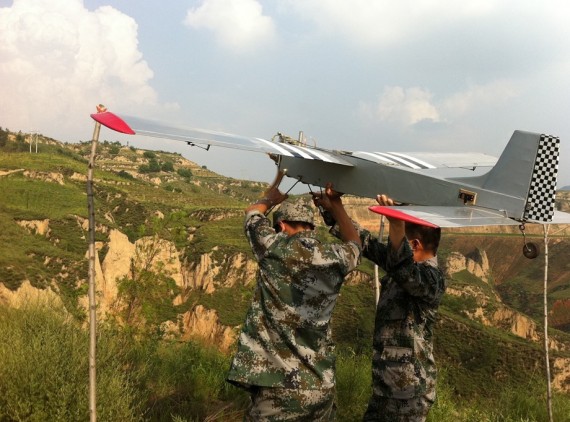An unmanned aircraft produced by Taiyuan Navigation Friend Aviation Technology is seen with Chinese military members (Company photo)