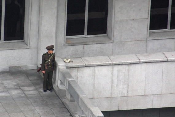 A guard stands next to a telephone in Pyongyang on September 10, 2010 (Photo: Roman Harak / CC-by-sa-2.0)